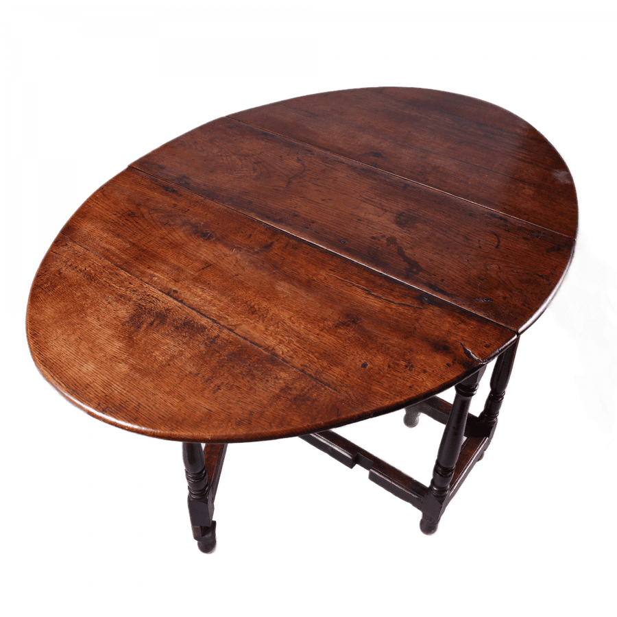 17th Century Oak drop leaf table with turned legs and stretchers, oval top in rich oak wood finish.