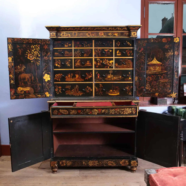 English Regency Black Japanned Chinoiserie Secretaire Cabinet with intricate gold and red raised detailing and multiple drawers and cupboards.