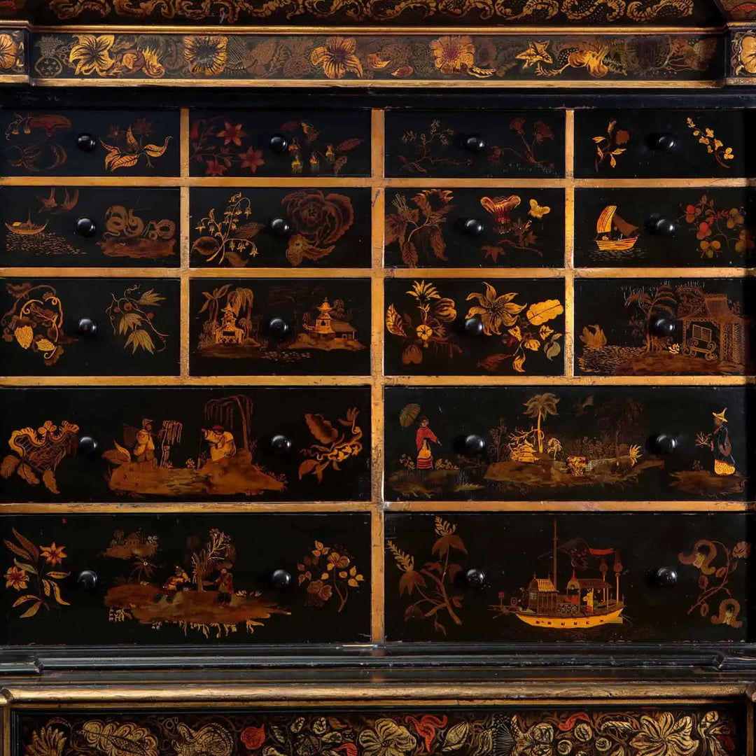 English Regency Black Japanned Chinoiserie Secretaire Cabinet with detailed gold and red floral and landscape drawer decorations.