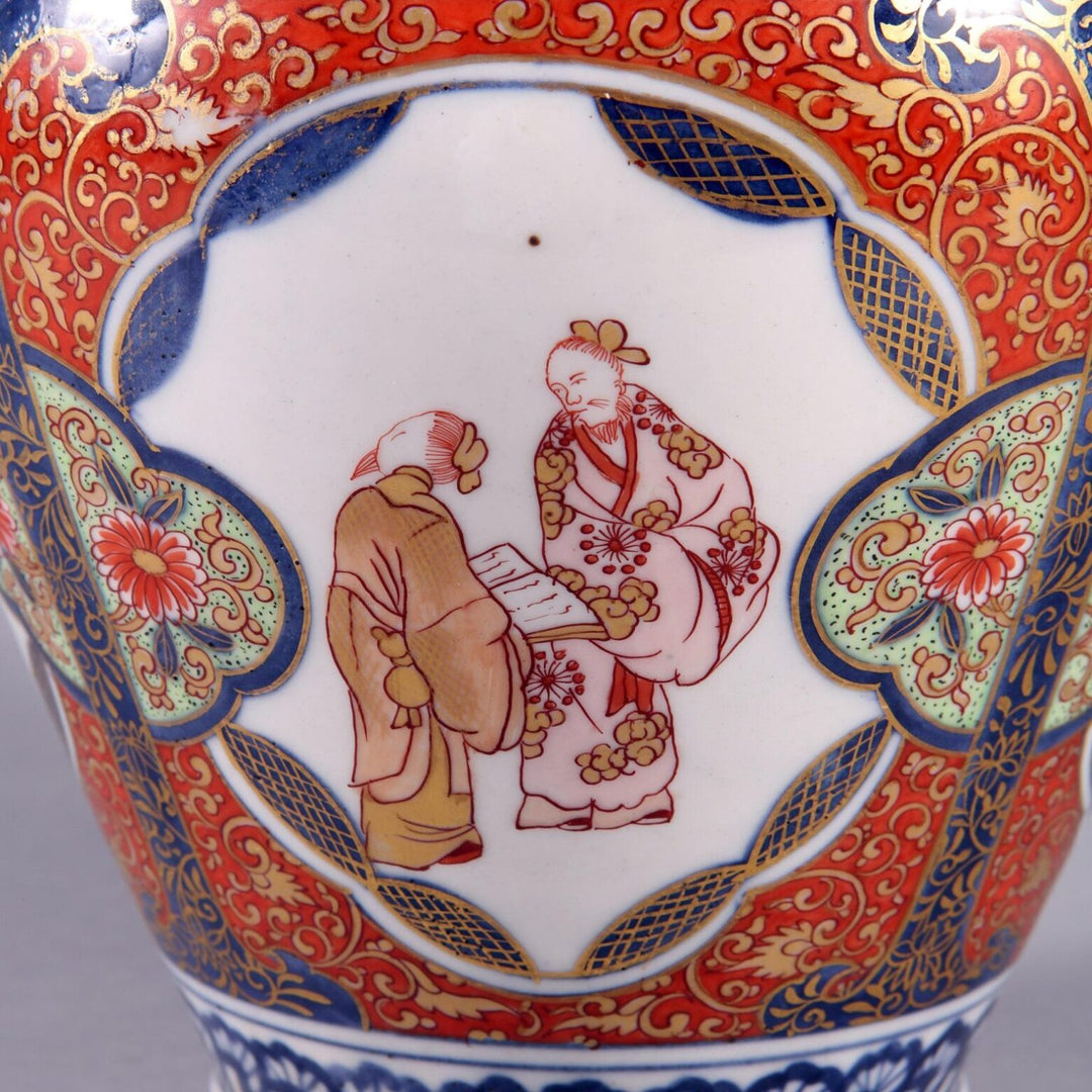 Near Pair of Japanese Imari Vases as Lamps with traditional red and blue porcelain design and detailed figures.