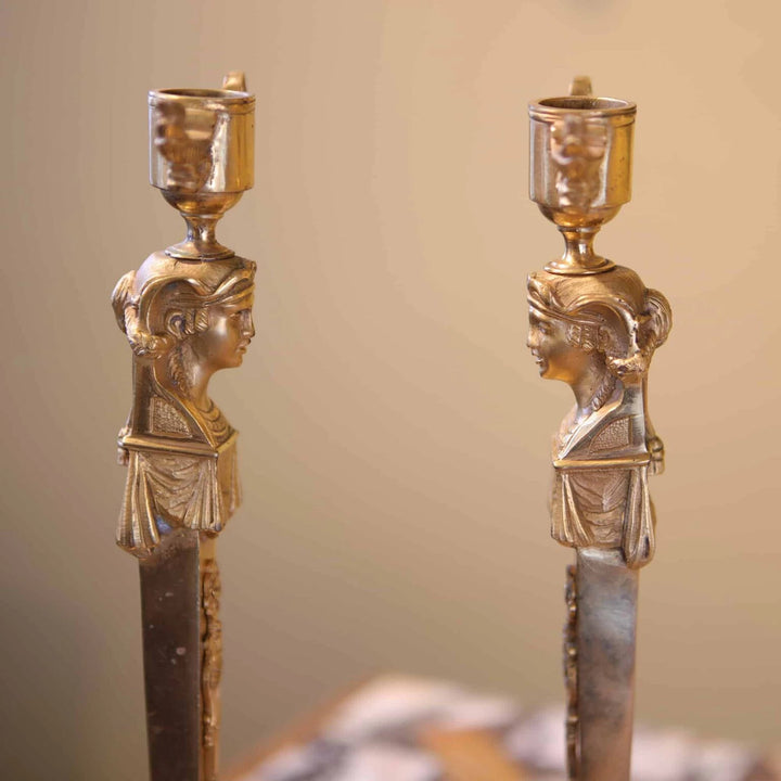 Pair Of Neo Egyptian Empire Gilt Bronze Candlesticks with female caryatid figures and lion mask handles, circa 1820 France.