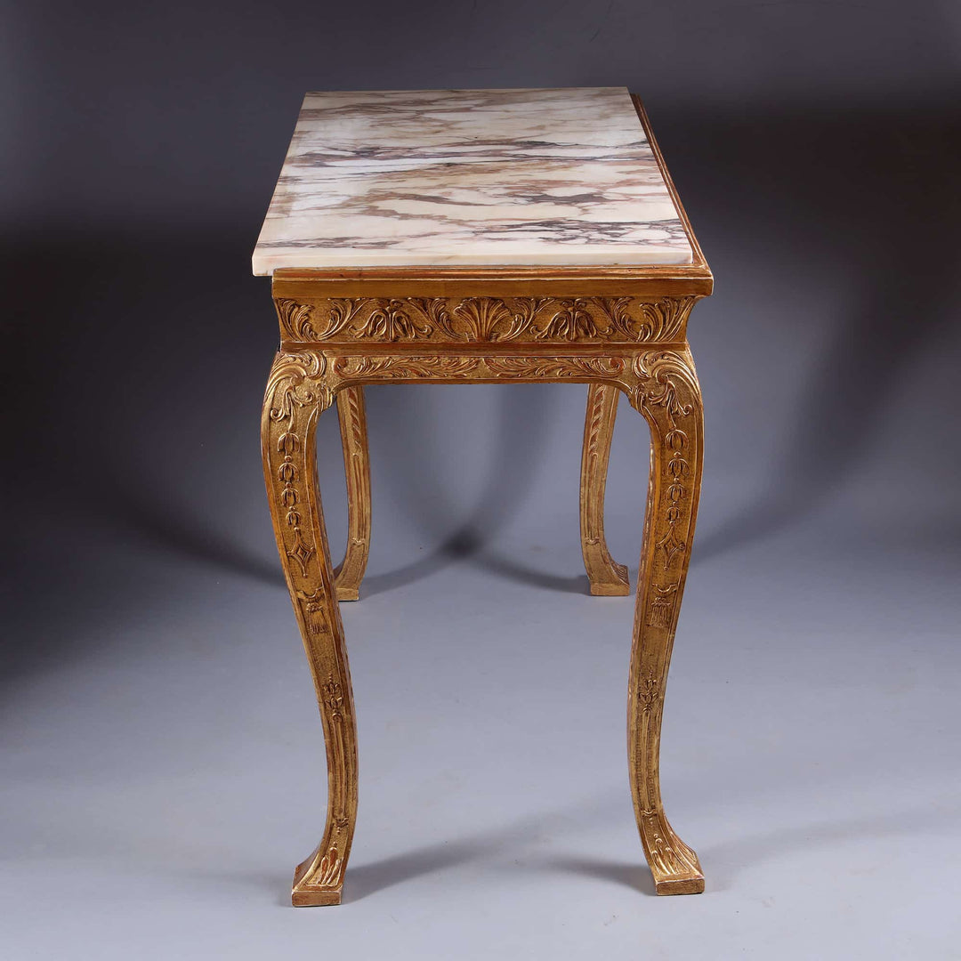 George I Gilt Gesso Side Table with marble top, intricate carvings, and gilt accents from 19th century England.