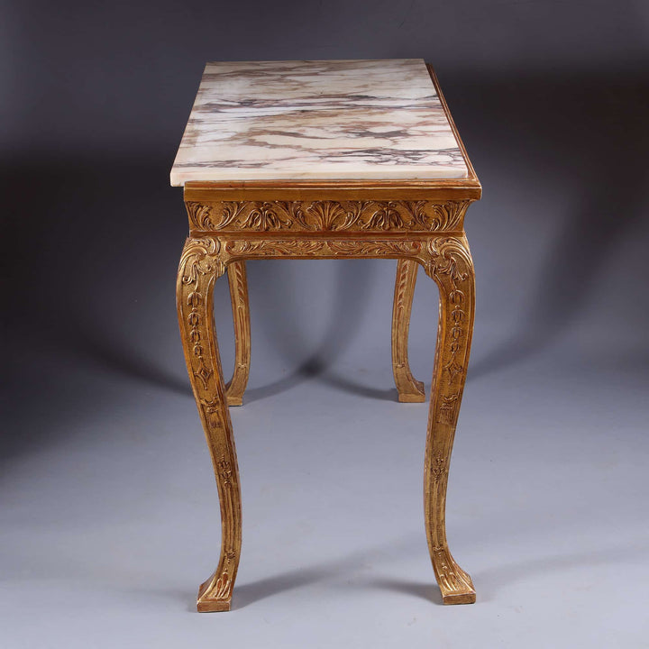 George I Gilt Gesso Side Table with marble top, intricate carvings, and gilt accents from 19th century England.