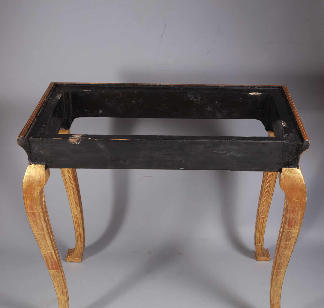 George I Gilt Gesso Side Table with carved gilt legs and black frame, missing its marble top, 19th Century.