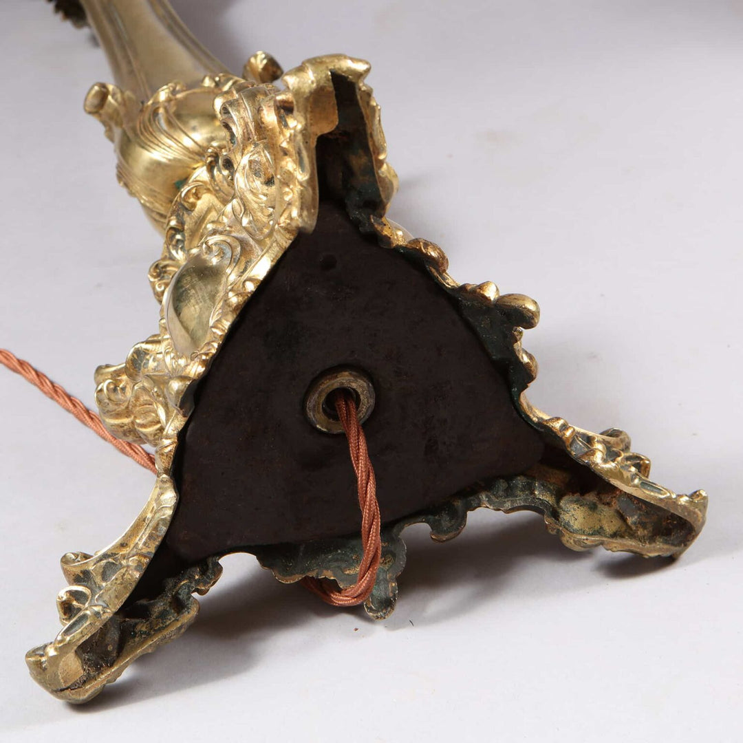 Pair of Brass Column Lamps with ornate bases and exposed wiring detail viewed from the bottom side angle.
