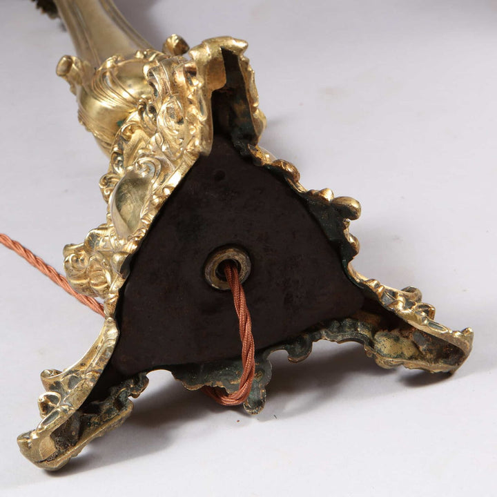 Pair of Brass Column Lamps with ornate bases and exposed wiring detail viewed from the bottom side angle.