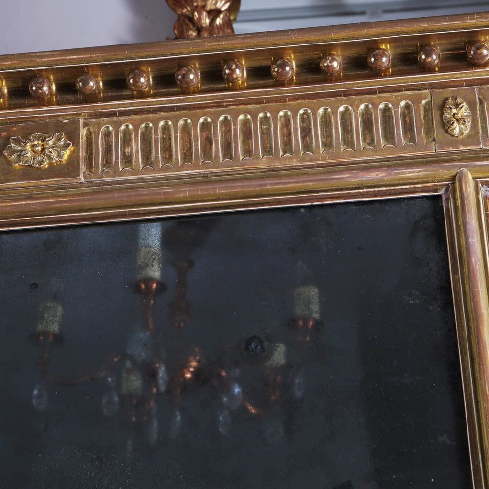 George III Three-plate Giltwood Overmantel Mirror with intricate giltwood frame and aged mirror panels circa 1780 England