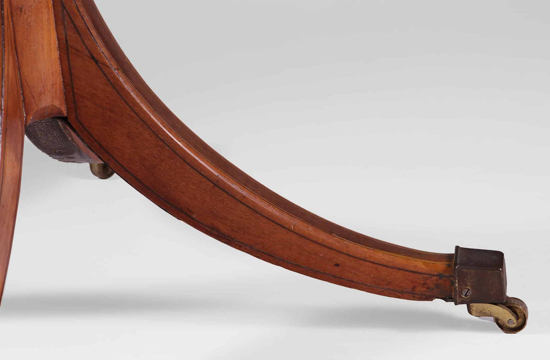 George III Sheraton Satinwood Occasional Table leg detail with caster and polished wood finish circa 1790 England.