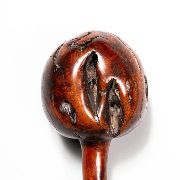 Fijian Throwing Club with round bulbous head featuring natural inclusions and a long handle with parallel tava tava lines.