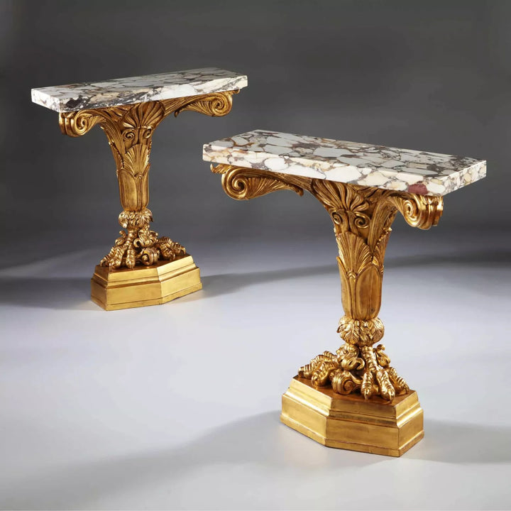 Pair of Antique Neo Classical Giltwood and Marble Monopedia Console Tables with ornate gilt carvings and marble tops.