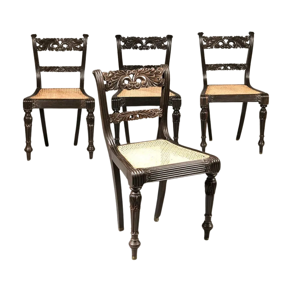 Set of four Anglo Indian ebony side chairs with intricate carvings and caned seats by Collection EE30