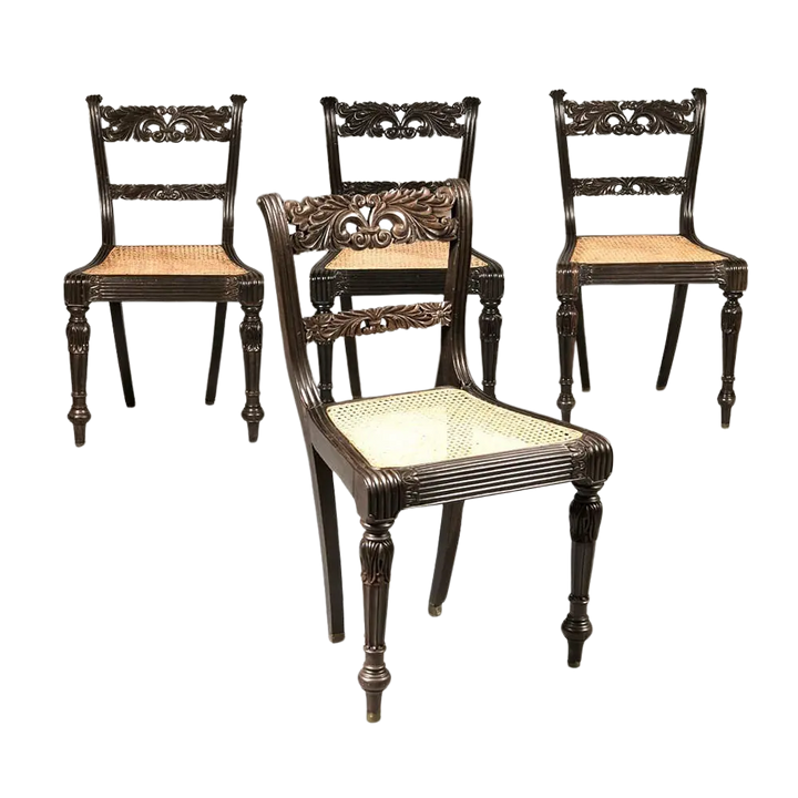 Set of four Anglo Indian ebony side chairs with intricate carvings and caned seats by Collection EE30