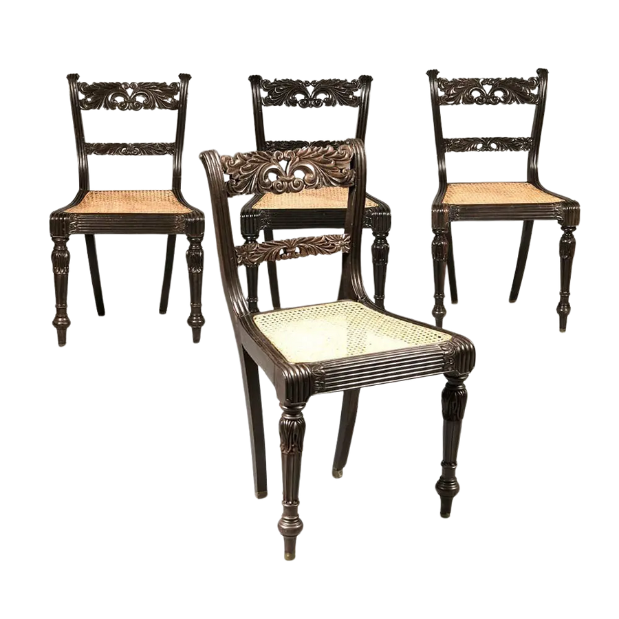 Set of four Anglo Indian ebony side chairs with intricate carvings and caned seats by Collection EE30