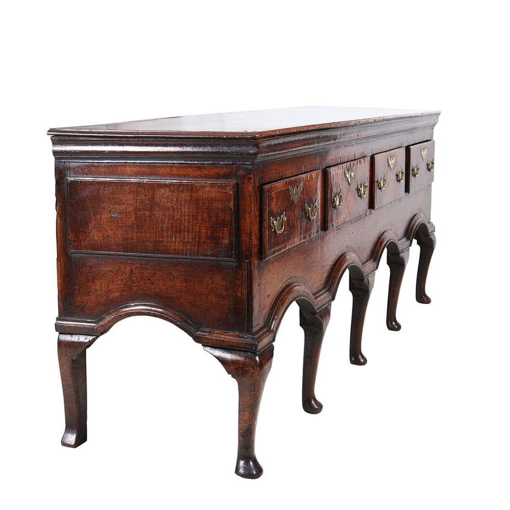 Early Georgian Oak Sideboard with four drawers, brass handles, cabriole legs, and polished oak finish circa 1720.