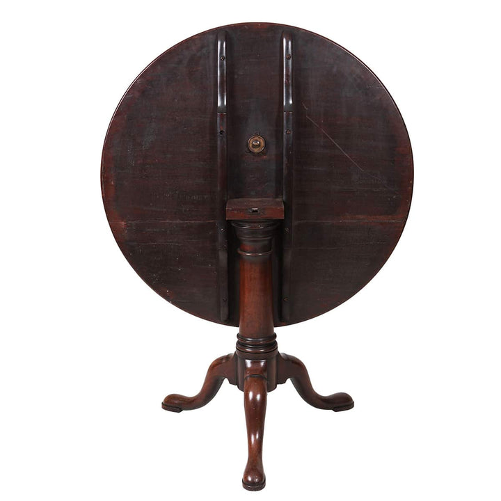 Georgian Mahogany Circular Tilt Top Tripod Table showing turned column base and three cabriole legs with pad feet.