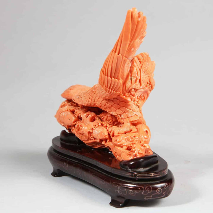 Intricately carved Japanese coral sculpture of a Steller’s Sea Eagle capturing a fish mounted on a wooden base by Nicholas Wells Antiques