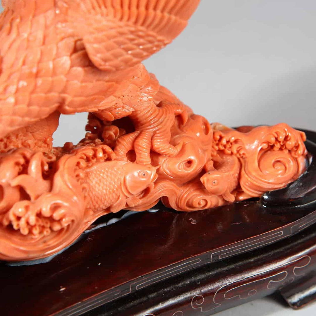 Close-up of a Japanese carved coral sculpture of an eagle catching a fish displayed by Nicholas Wells Antiques