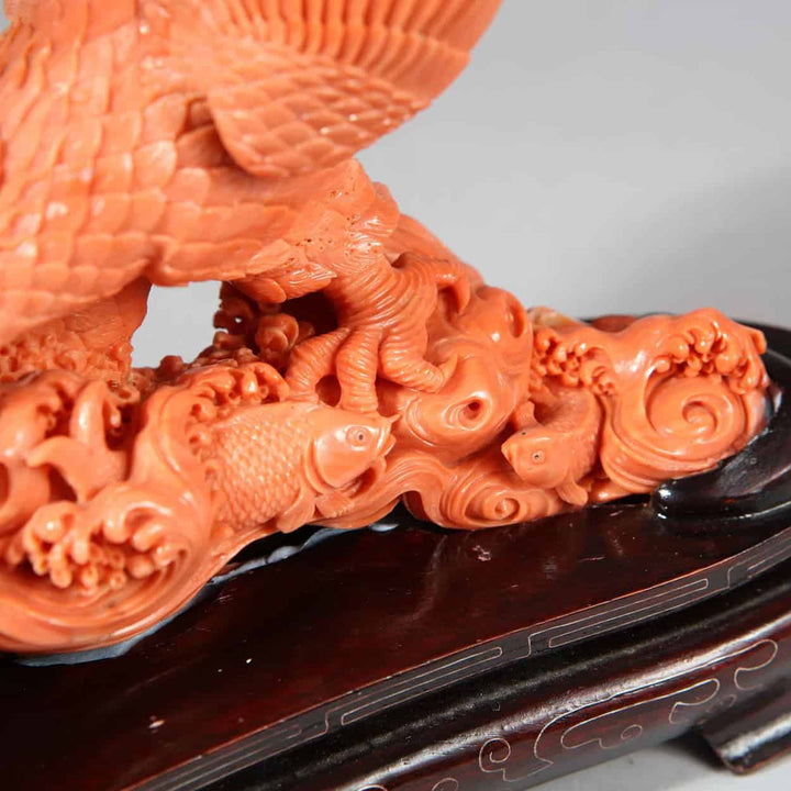 Close-up of a Japanese carved coral sculpture of an eagle catching a fish displayed by Nicholas Wells Antiques