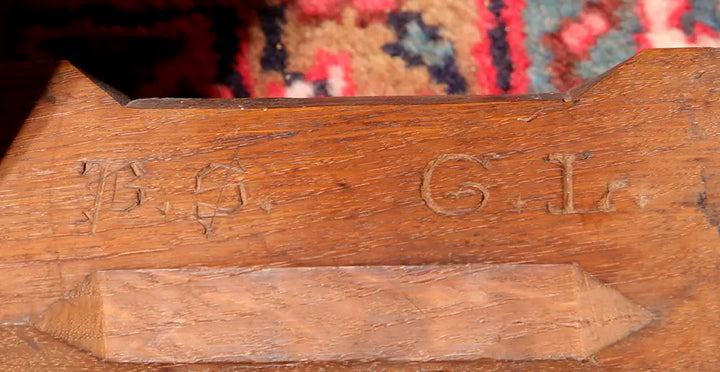 Close-up of gothic script initials on Arts and Crafts Gothic Revival Etagere, English oak, circa 1900 craftsmanship detail.