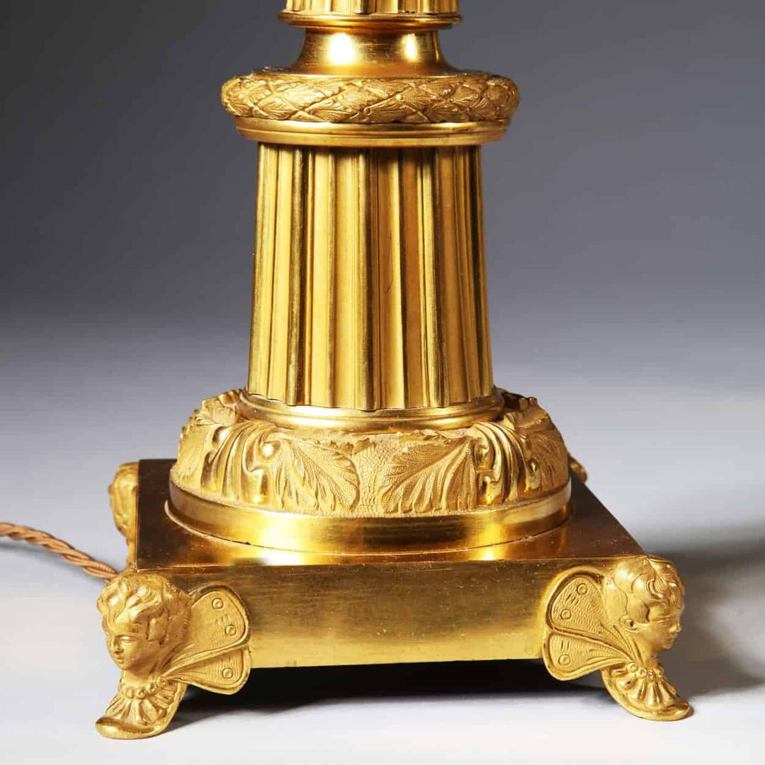 Pair Of French Gilt Bronze And Tole Antique Gold Column Table Lamps featuring detailed antique gold base and column design.