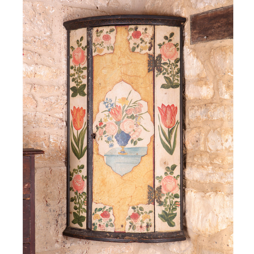 George I Japanned Bow Front Hanging Corner Cupboard with floral tulip and rose decoration on aged paint.
