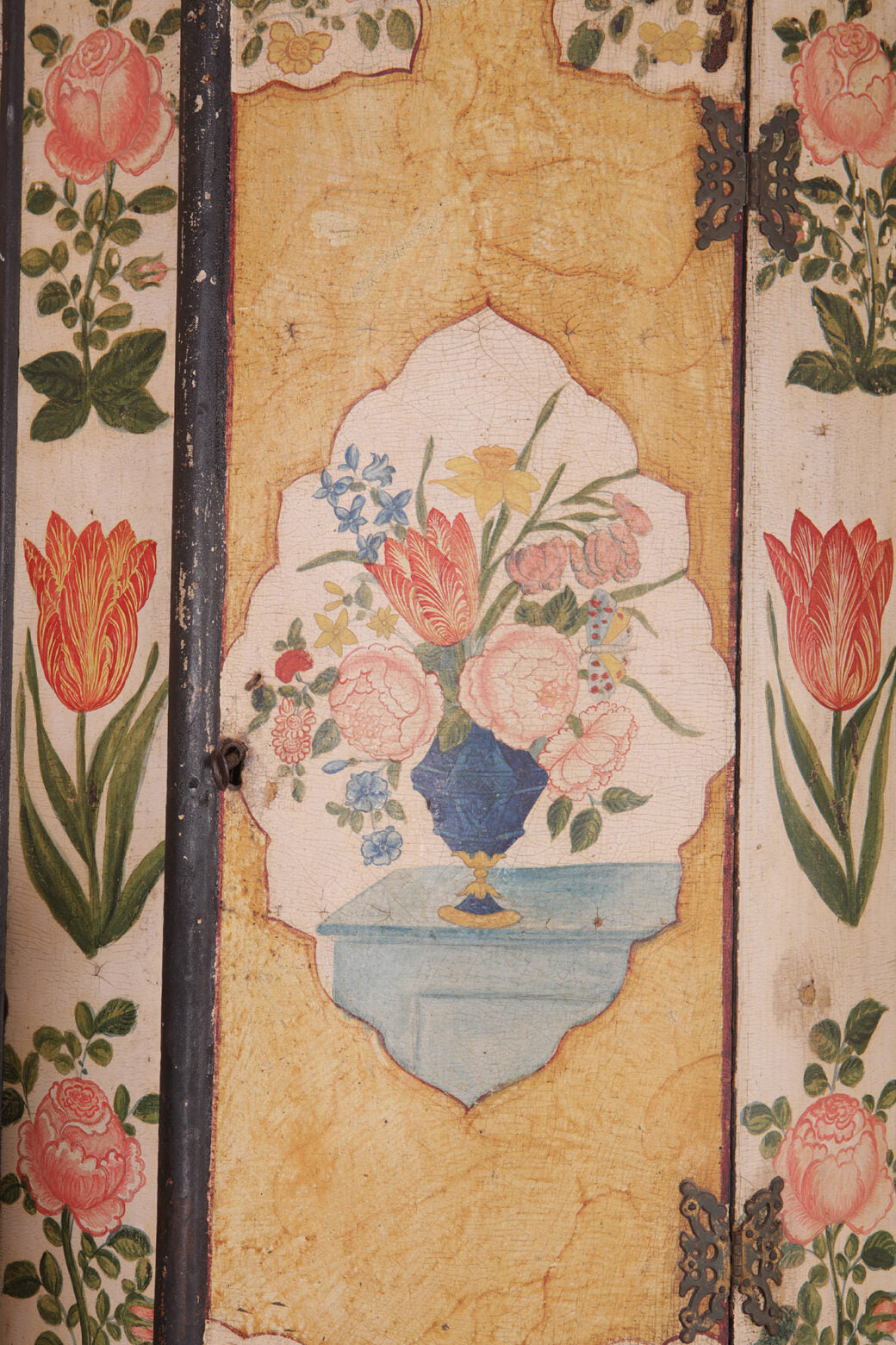 George I Japanned Bow Front Hanging Corner Cupboard with polychrome floral vase and tulip decoration on aged surface.