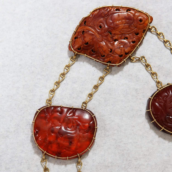 Close-up of Chinese carved amber pendant necklace with gold mounts by Nicholas Wells Antiques
