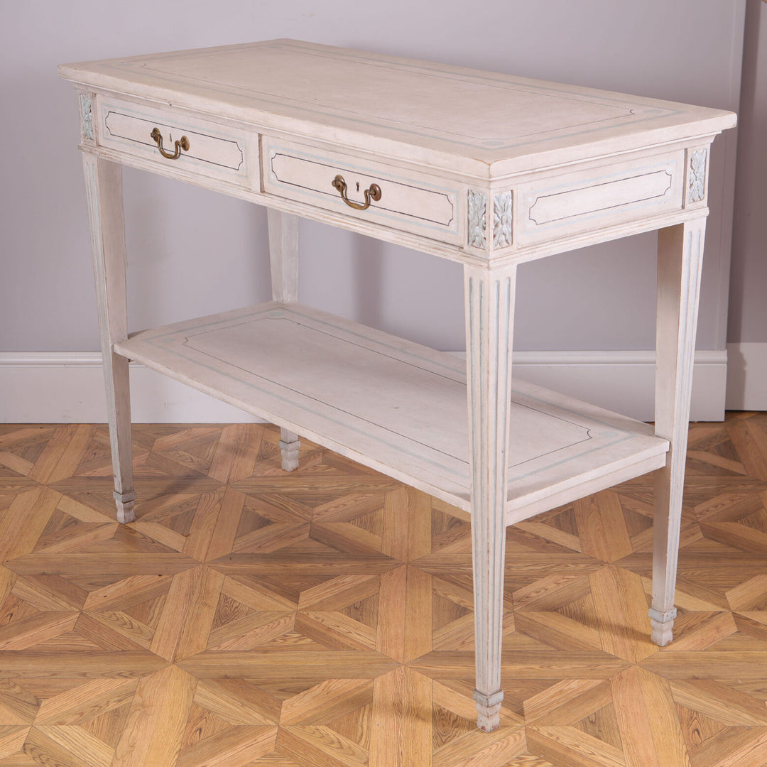 Pair of White Painted Side Tables with twin drawers, brass handles, tapered legs, and lower tier shelf in white and blue detailing.