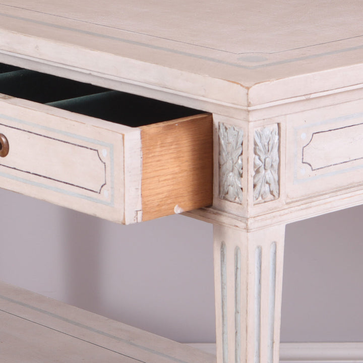 Pair of White Painted Side Tables with open drawer, brass handles, blue detailing, tapered legs, and lower shelf circa 1900.