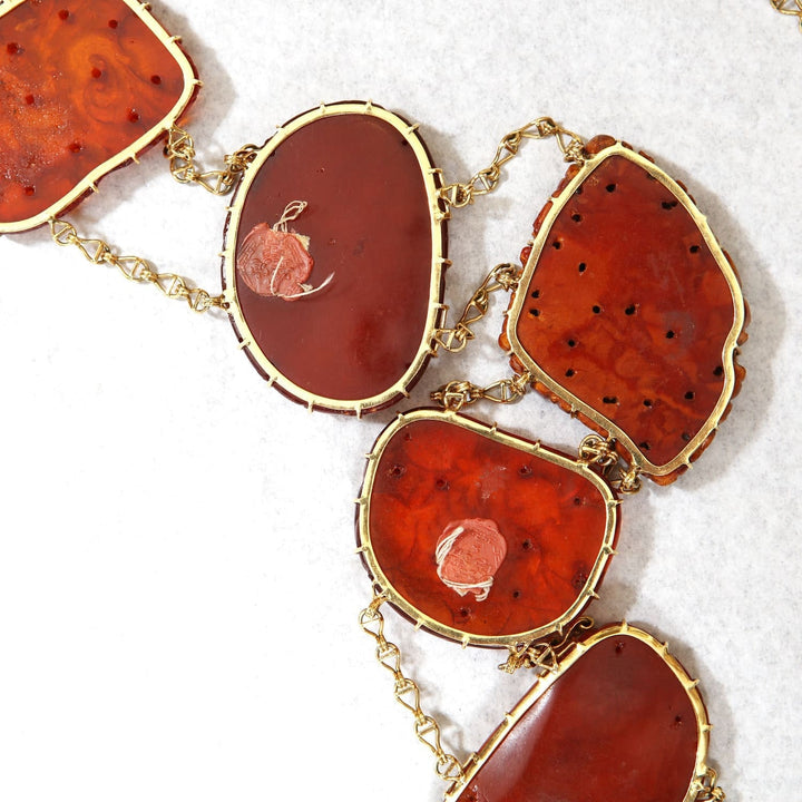 Chinese carved amber gold mounted necklace from Nicholas Wells Antiques with warm golden hues and intricate details