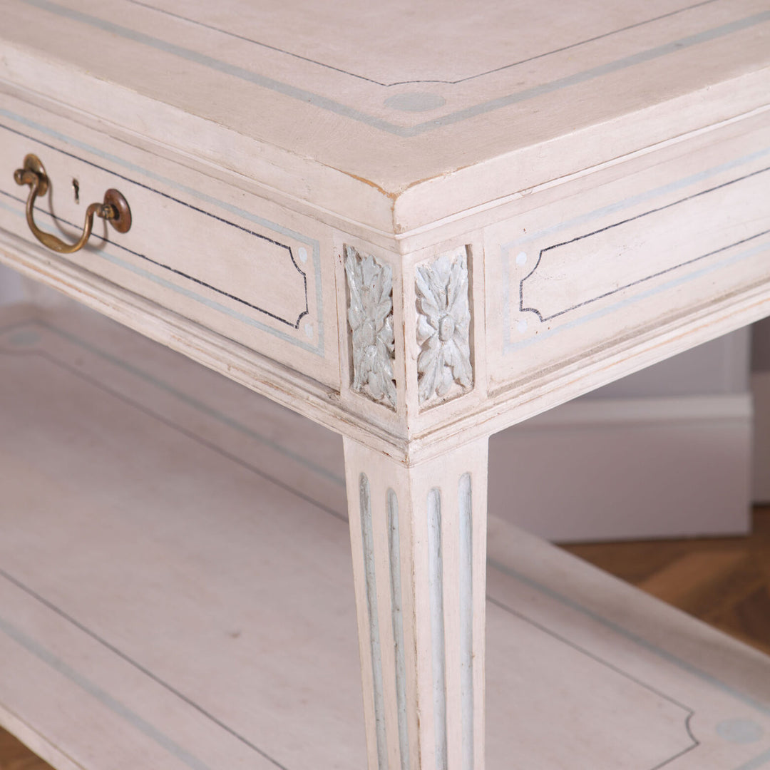Pair of White Painted Side Tables with twin drawers, brass handles, blue detailing, and tapered legs supporting a lower tier.