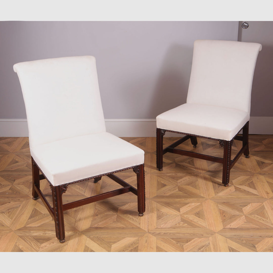 Pair of George III upholstered mahogany side chairs with white fabric seats from Collection CK20 on parquet floor.