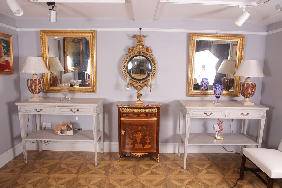 Pair of White Painted Side Tables with twin drawers, brass handles, blue detailing, tapered legs, and lower tier shelves.