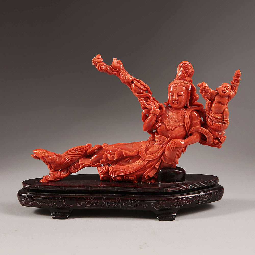 Chinese carved precious coral reclining Guanyin with attendants on wooden base by Nicholas Wells Antiques