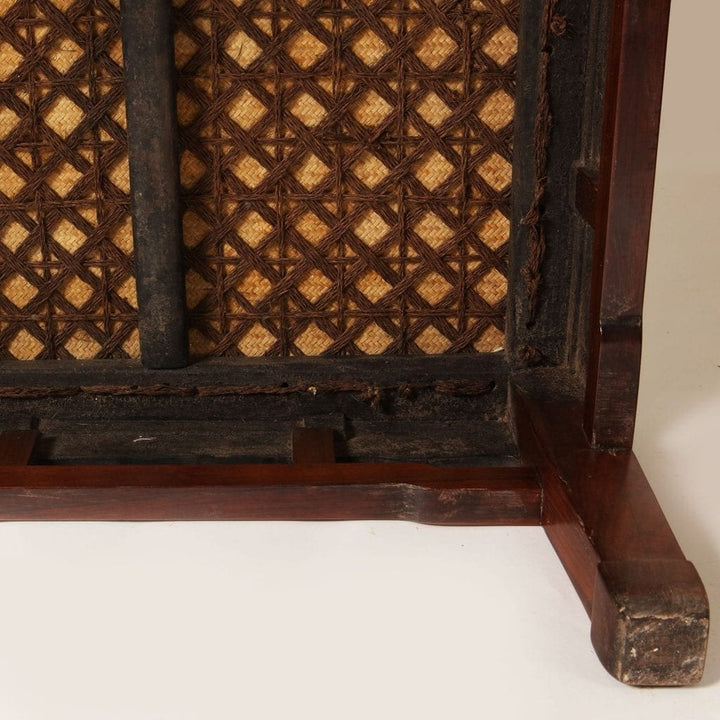 HUANGHUALI SQUARE MEDITATION STOOL, CHANDENG with cane seat and carved square legs in aged warm golden brown wood.