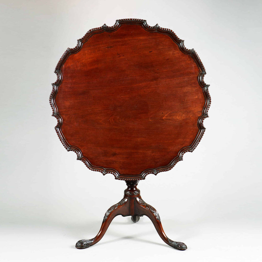George III Mahogany Tripod Table with scalloped pie crust top and carved cabriole legs, circa 1765 England.