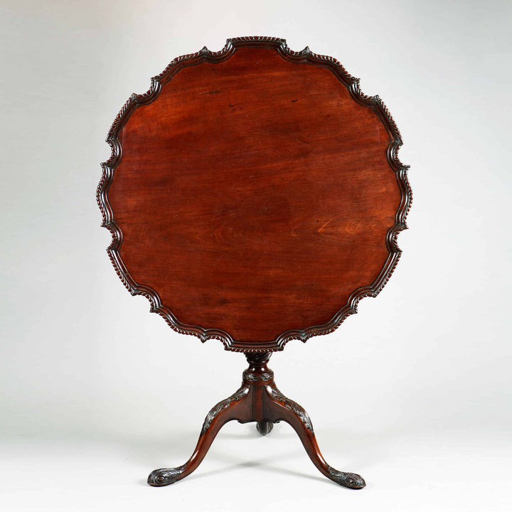 George III Mahogany Tripod Table with scalloped pie crust top and carved cabriole legs, circa 1765 England.