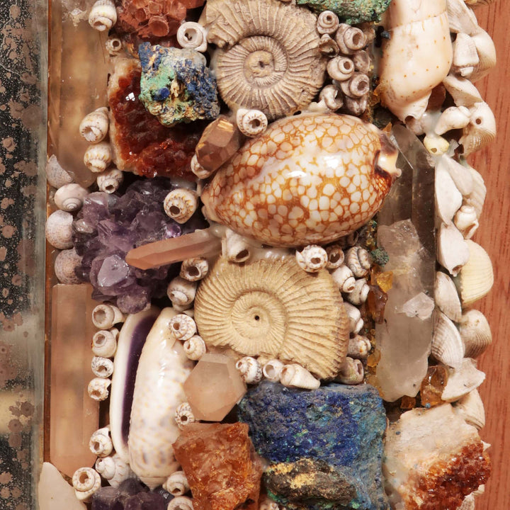 Vintage Crystal and Shell Grotto Mirror close-up showing shells, corals, stones, fossils, and crystals on giltwood frame.
