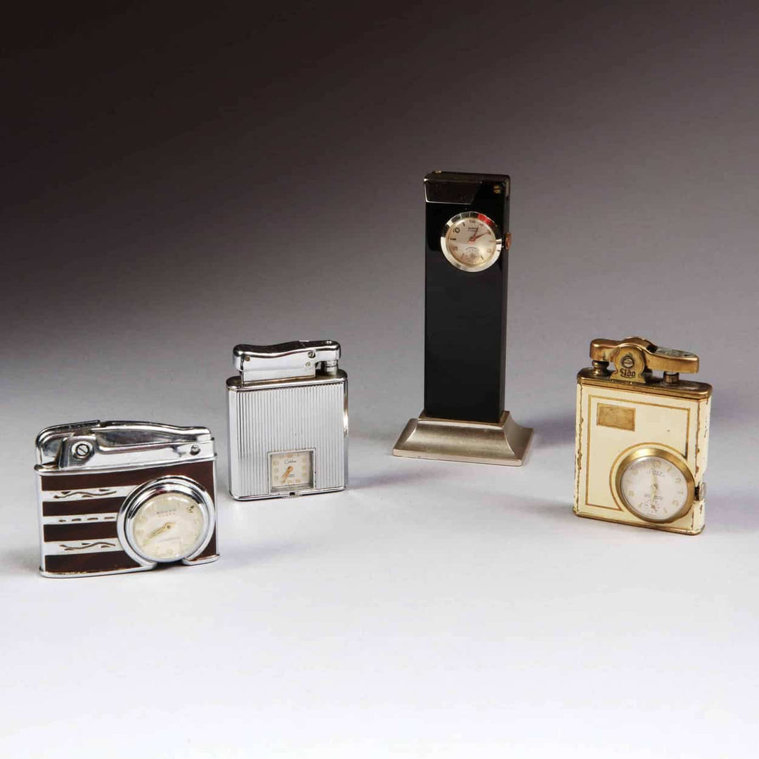 Mid 20th century - A collection of four watch mounted lighters