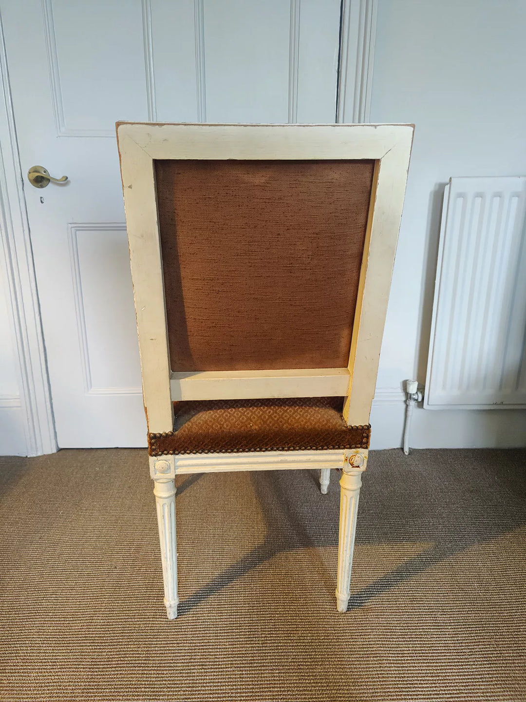 Rear view of a white painted Louis XVI side chair with original upholstery, offered by Nicholas Wells Antiques