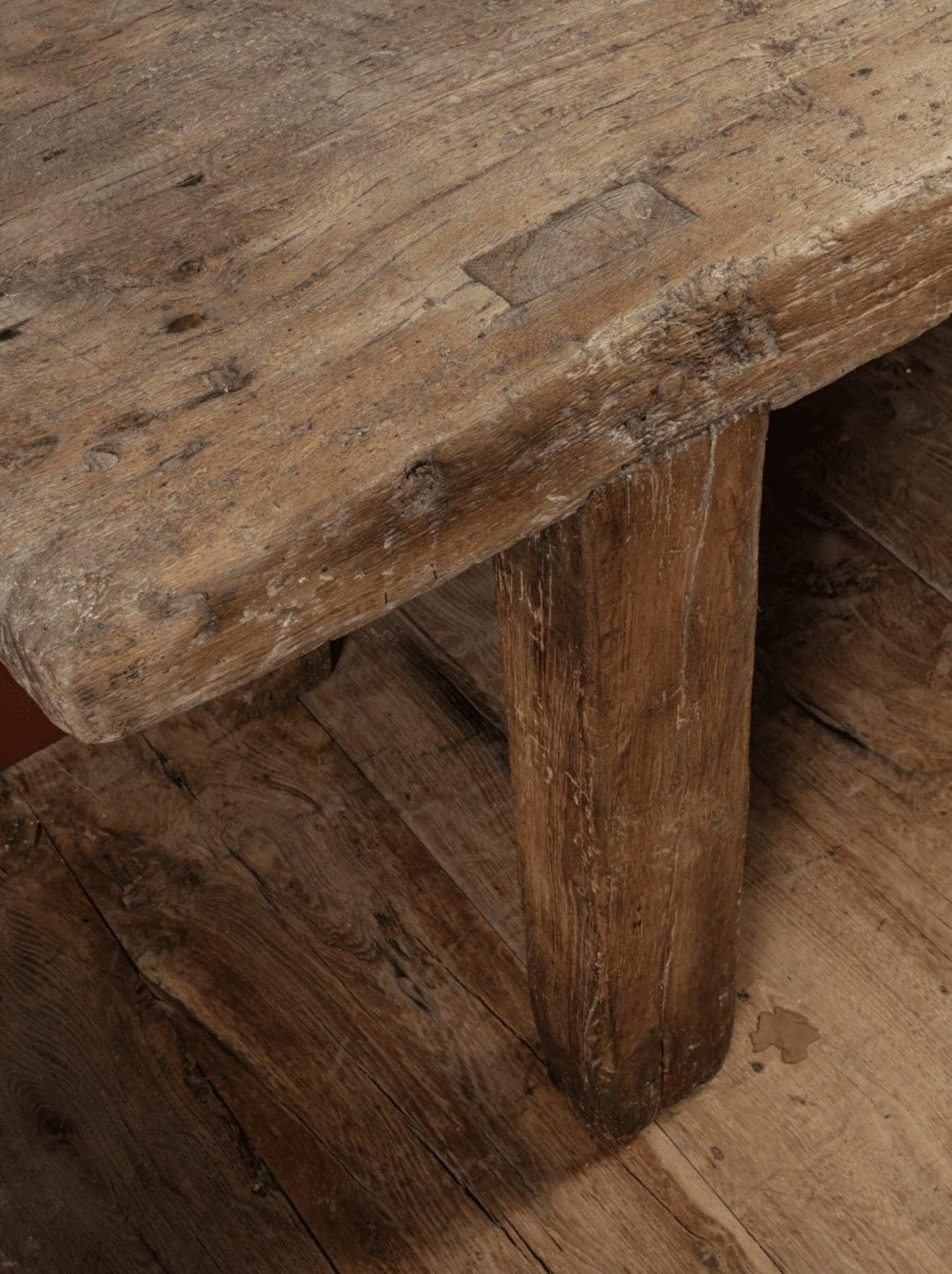 French 18th Century Rustic Farm Table showing worn elm wood top and robust leg, reflecting antique farmhouse charm.