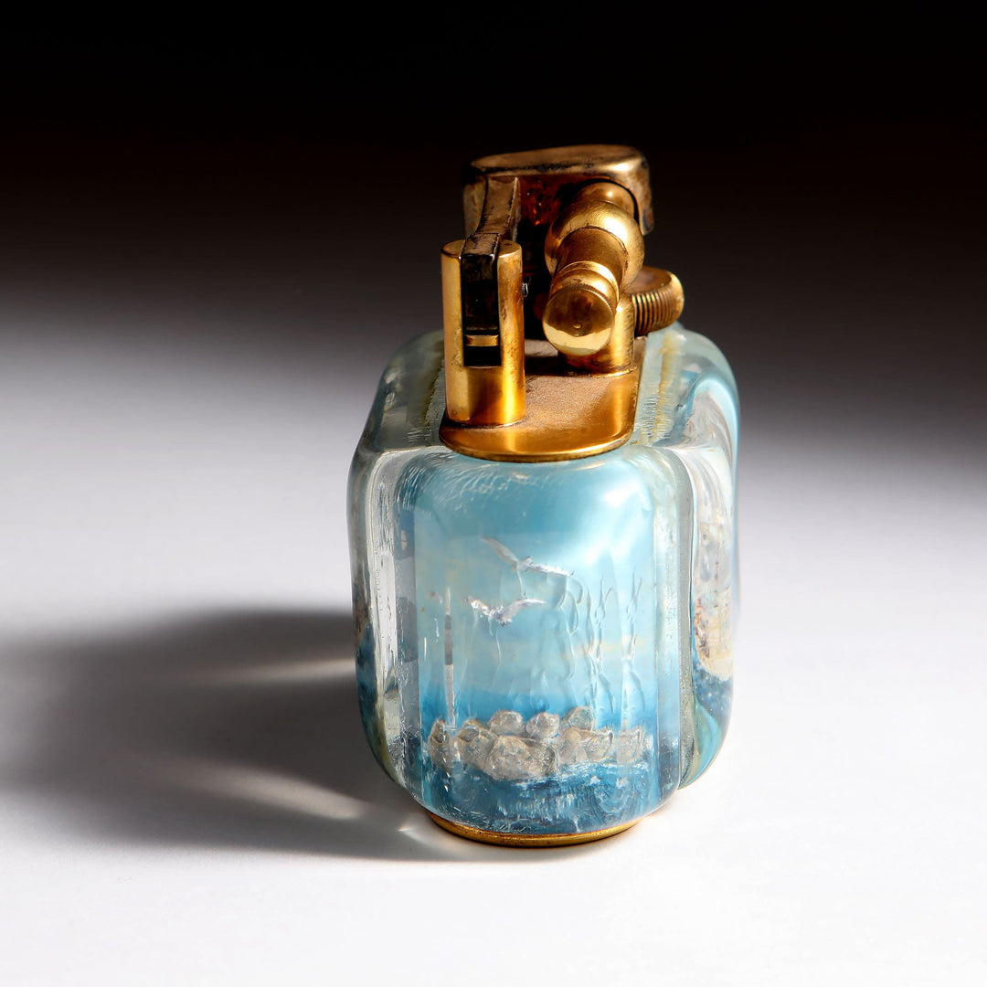 Vintage Dunhill Aquarium Ship Lighter by Collection JA10 with gold-plated top and blue lucite base depicting HMS Royal William