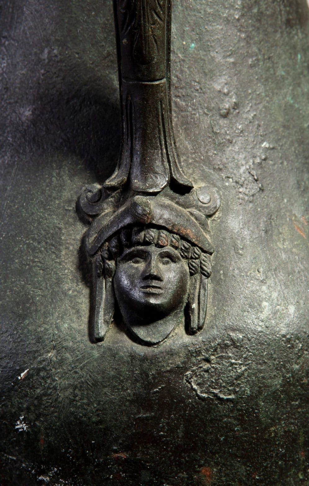 Close-up of bronze Neapolitan vase handle featuring a classical face detail from Collection TH20.