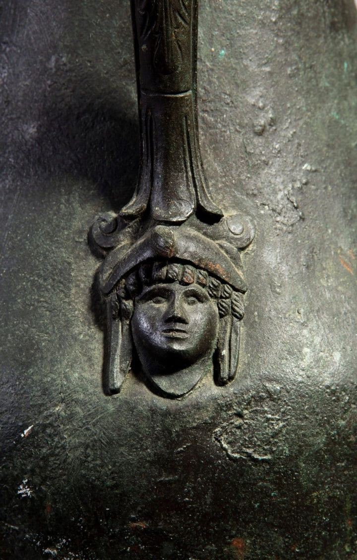 Close-up of bronze Neapolitan vase handle featuring a classical face detail from Collection TH20.