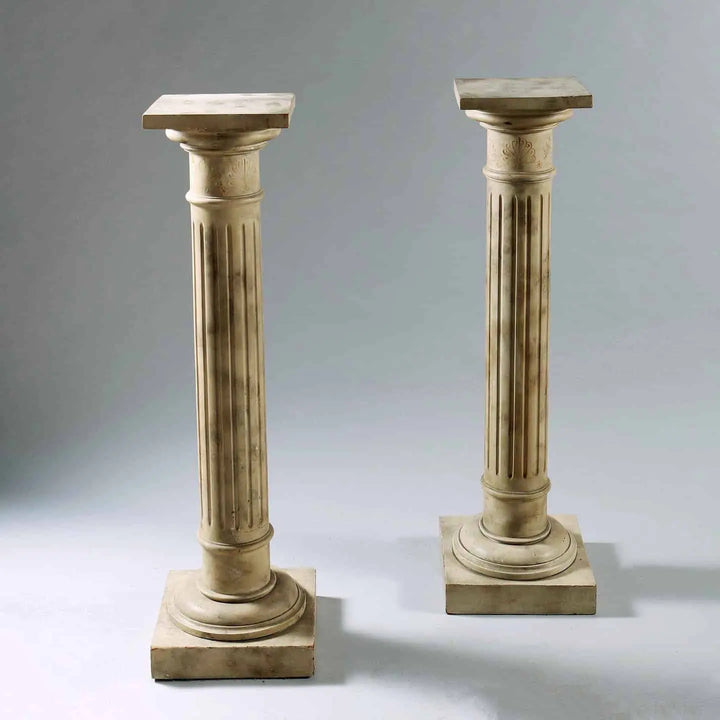 Pair of mid century faux marble painted column pedestals in cream with fluted design for antique sculpture display.