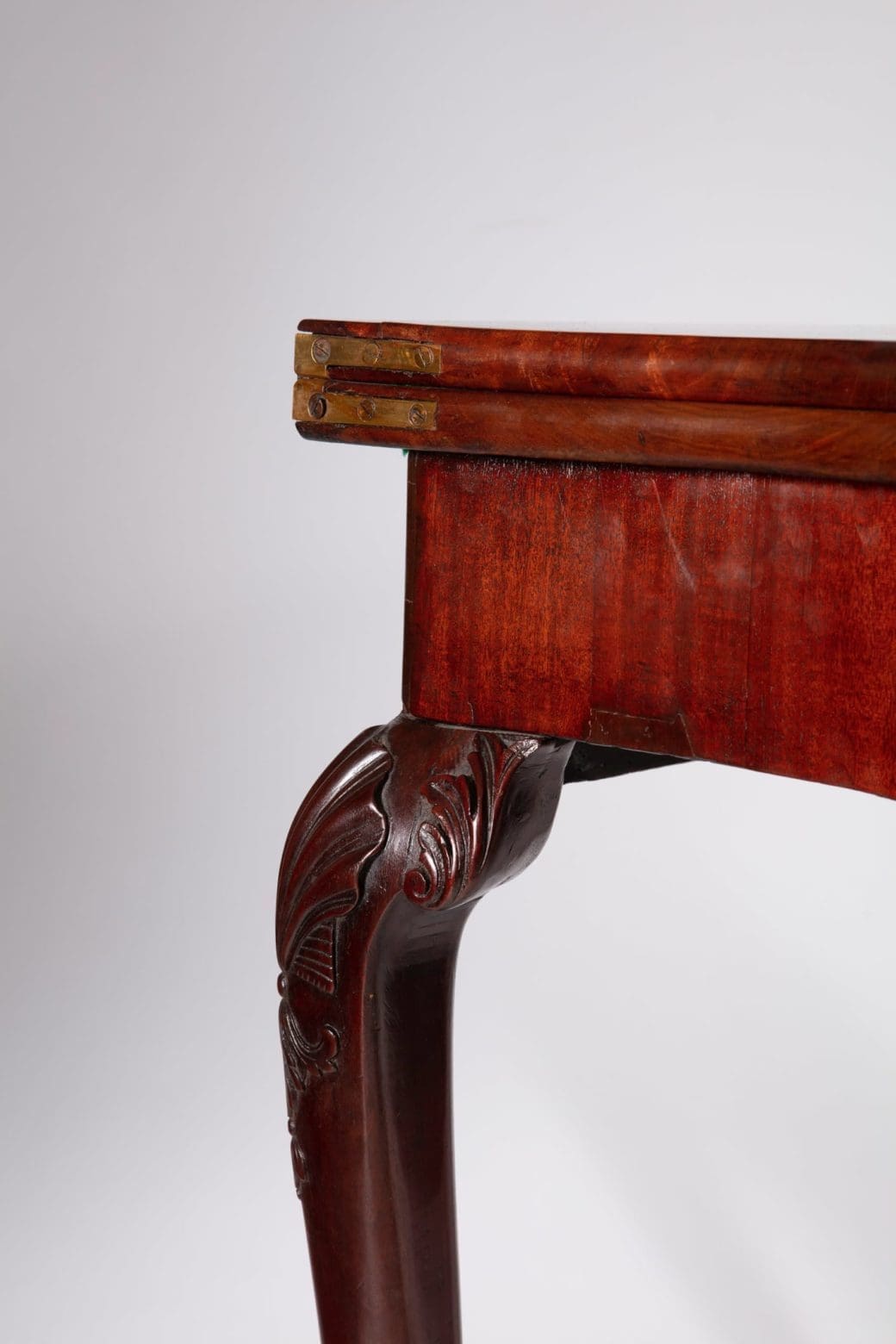 George III Mahogany Card Table leg with intricate carvings and rich mahogany finish from mid-18th century England.