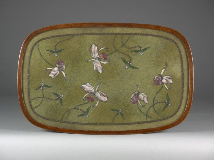 Oval table with beadwork top featuring irises on a variegated green ground with stained beech frame circa 1900.