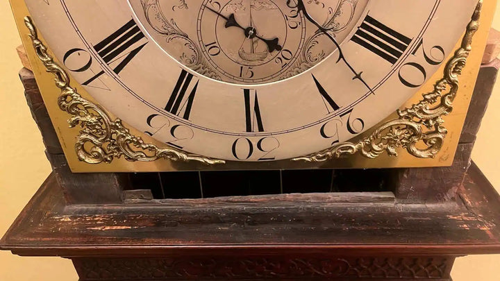 Close-up of a Sanders of Manchester Georgian longcase clock face and ornate mahogany base by Collection PK10