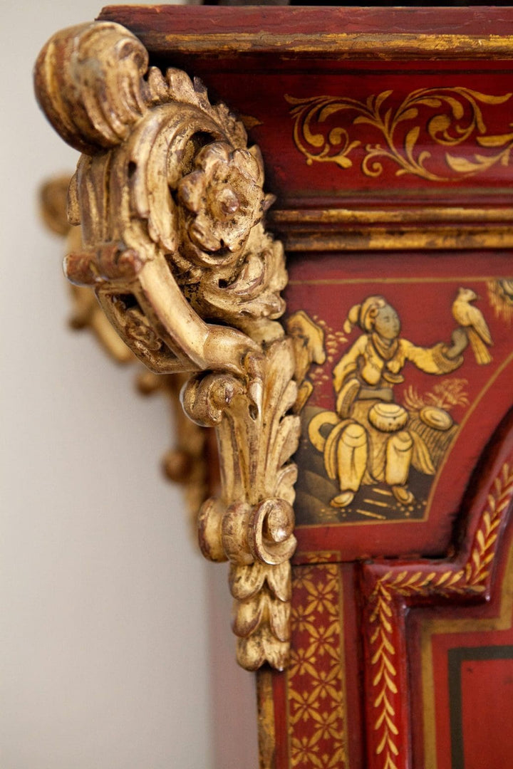 Close-up of gilt carved bracket and chinoiserie decoration on red japanned Austin of Shoreditch clock by Collection TH20