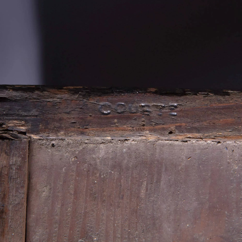 Close-up of stamped COURTE on the French provincial Louis XVI commode with burr walnut veneer and marble top.